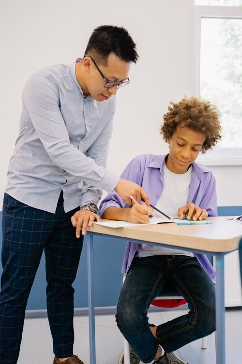 Mentor guiding students in a classroom discussion